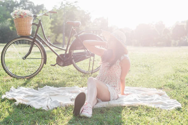 Woman sitting on picnic rug