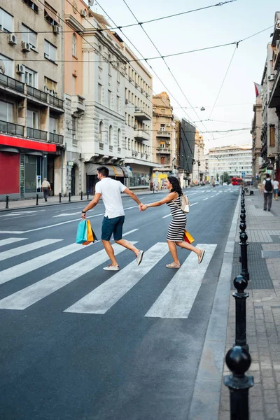 Couple running across the street