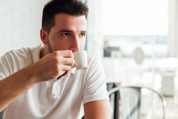 https://st3.depositphotos.com/5705508/17628/i/450/depositphotos_176285434-stock-photo-handsome-man-drinking-coffee-sitting.jpg