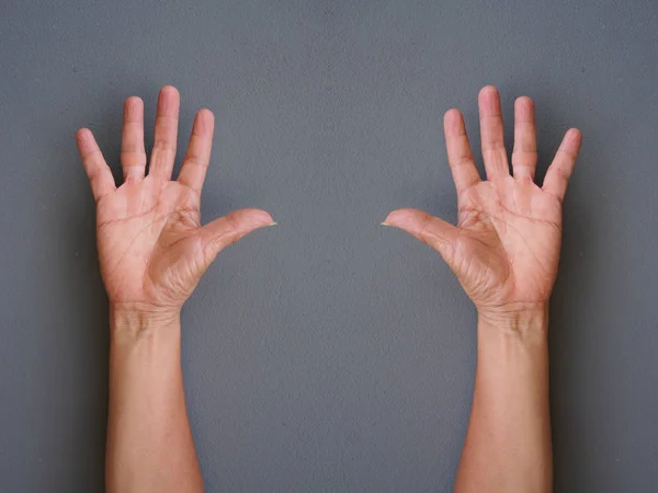 Hands making raise hands up on gray background — Stock Photo, Image