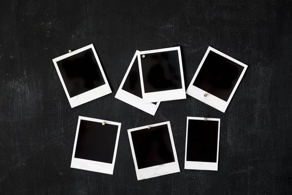 Blank retro photo frames attached to a metal blackboard with magnet Stock Photo