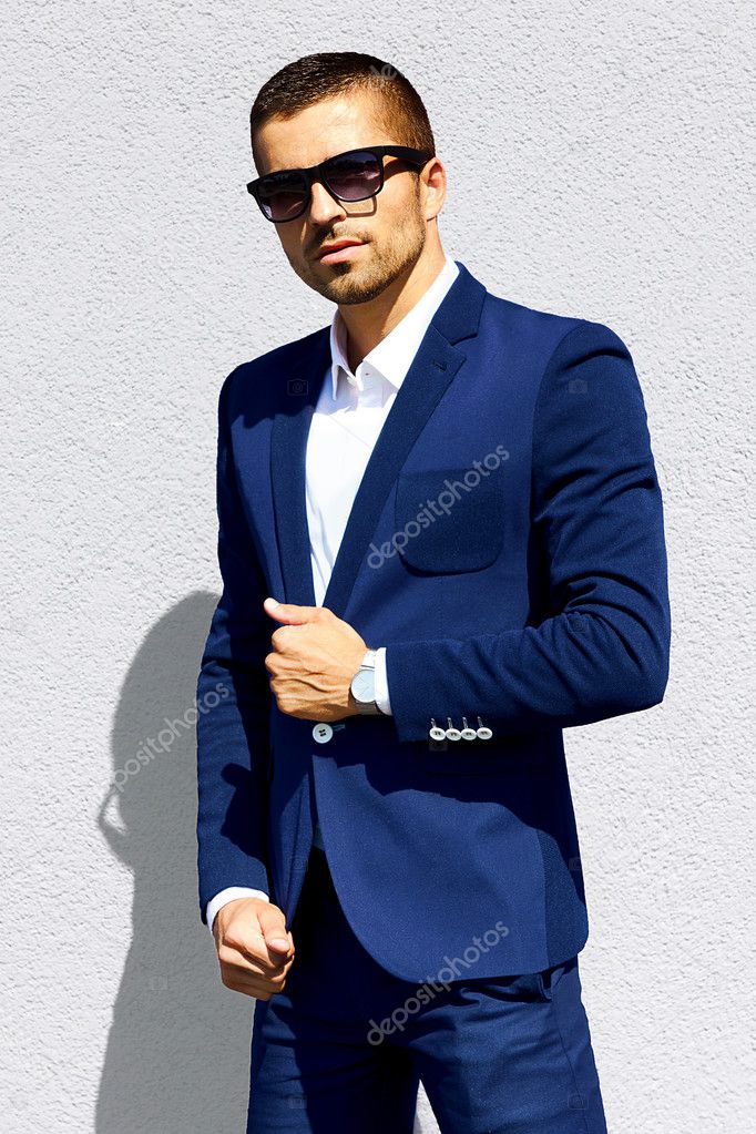 man in  blue suit and sunglasses standing