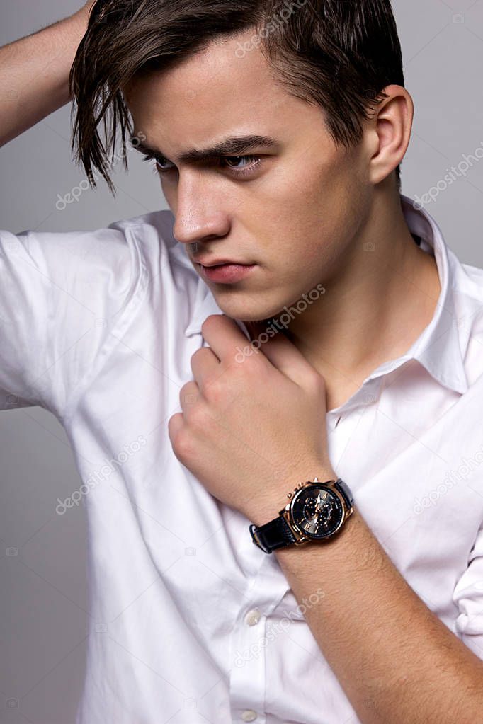 young man in white shirt wearing watches