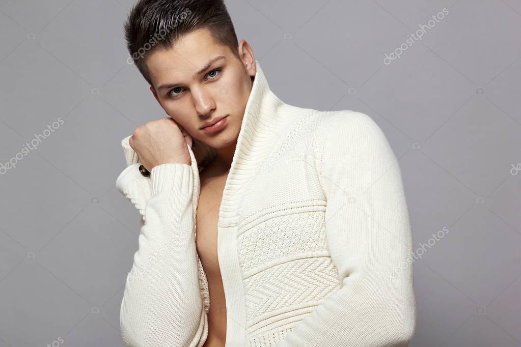 Sexy young man in a white a jacket portrait