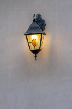 Duvardaki eski sokak lambası yanar