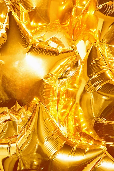 Zlaté balónky hvězdy zářit a lesk — Stock fotografie