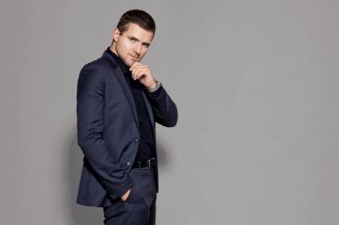 gri arka plan stüdyo üzerinde mavi elbiseli adam