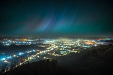 Gece şehrinin üzerinde yıldızlı gökyüzü