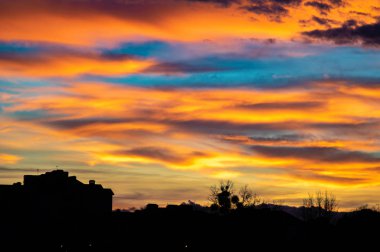 Şehrin evlerinin üzerinde renkli günbatımı gökyüzü