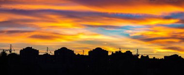 Renkli günbatımı manzarası ev siluetleri üzerinde gökyüzü