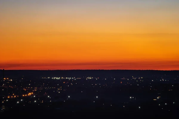 Sunset on the background of the city in spring — Stock Photo, Image