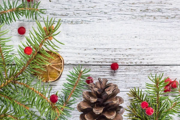 Ramas de Navidad con conos de bayas viburnum y rodaja de limón seco — Foto de Stock