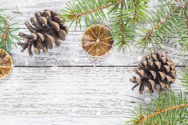 Christmas fir branches with cones and dry lemon slice