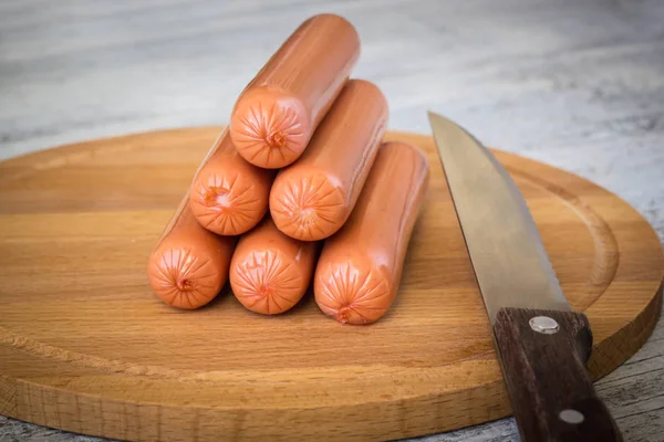 Sausages on rustic wooden background — Stock Photo, Image