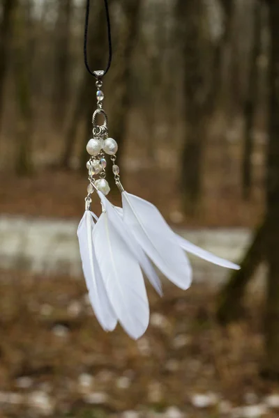 White pendant with feathers and beads handmade