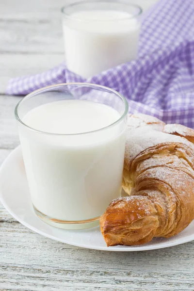 Croissant con leche en la vieja mesa de madera para el desayuno de fondo . —  Fotos de Stock