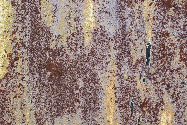 Rusted painted metal wall corrosion with streaks of rust