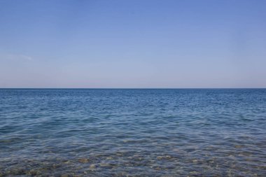 Mavi deniz dalgaları yumuşak yüzeyi okyanus ve mavi gökyüzü arka plan sakin