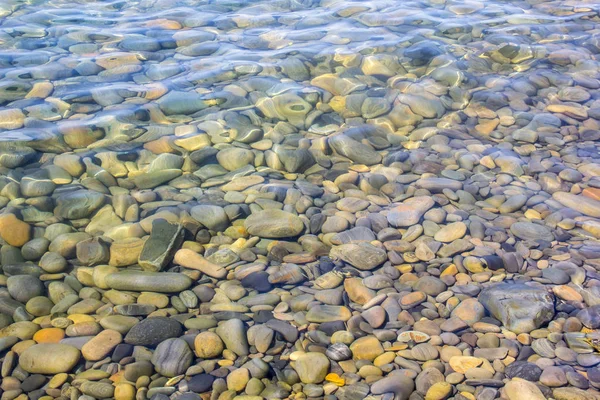 Mar e seixos debaixo de água em uma praia. Fundo de seixos — Fotografia de Stock