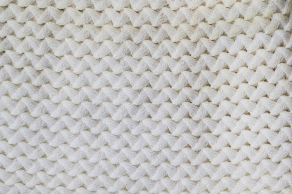 Πουλόβερ ή κασκόλ μοτίβο από λευκό πλεκτό ύφασμα υφή φόντου — Φωτογραφία Αρχείου