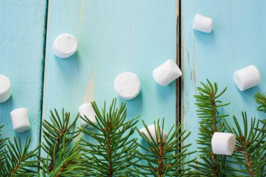 Çam ağacı ve ahşap arka plan üzerinde marshmallows dalı ile Noel sınır