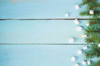 Çam ağacı ve ahşap arka plan üzerinde marshmallows dalı ile Noel sınır