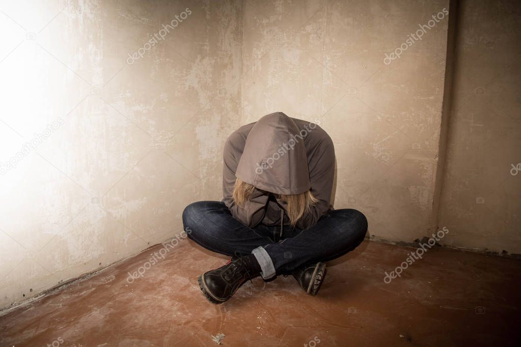 Portrait of man sad, drug addict man sitting on the floor in corner