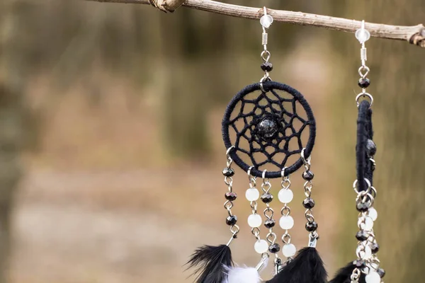 Handmade earrings dream catcher with feathers threads and beads rope hanging — Stock Photo, Image