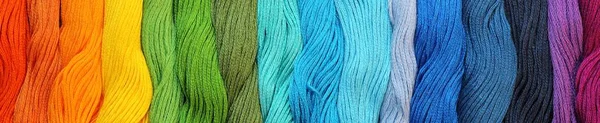 Banner of Colorful cotton craft threads on burlap