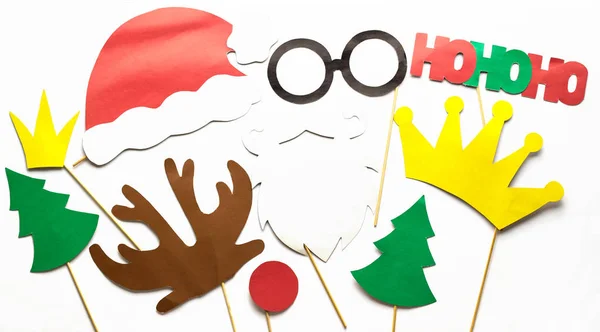 Foto estande adereços coloridos para bigode festa de Natal, santa claus, abeto, óculos, coroa, chifre, nariz, chapéu . — Fotografia de Stock