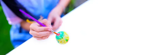 Happy Easter. woman painting colorful easter eggs