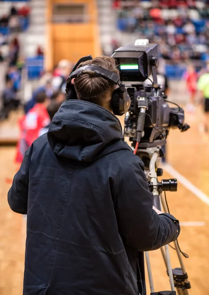 video operator recording a sports match on a professional video