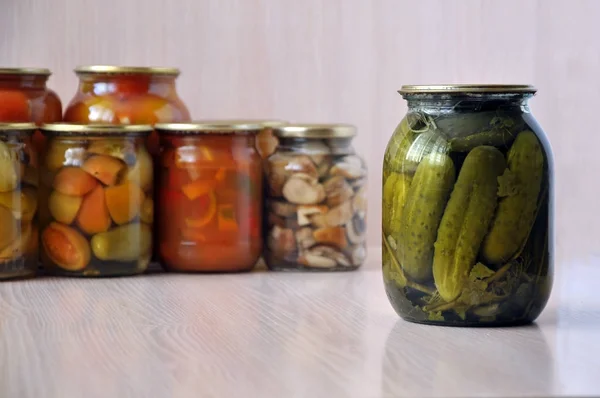 Glass jars with canned cucumbers — Stock Photo, Image