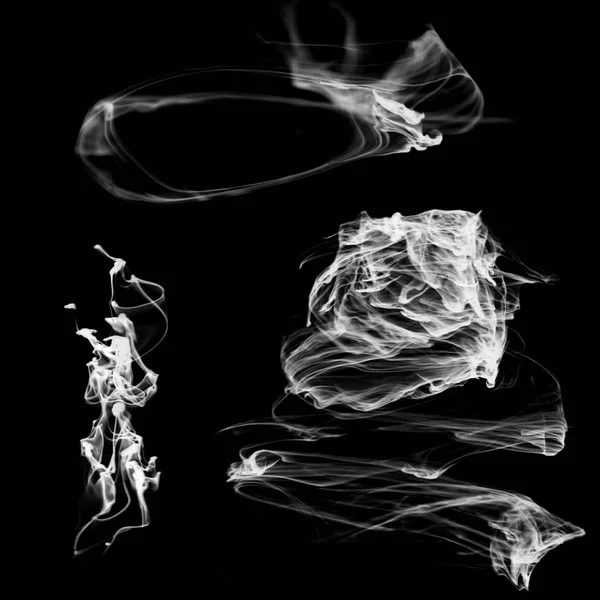 A set of shapeless smoke jets for design on a black background.