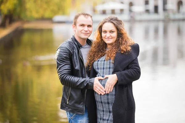 Stock image Happy pregnant couple  in autumn background