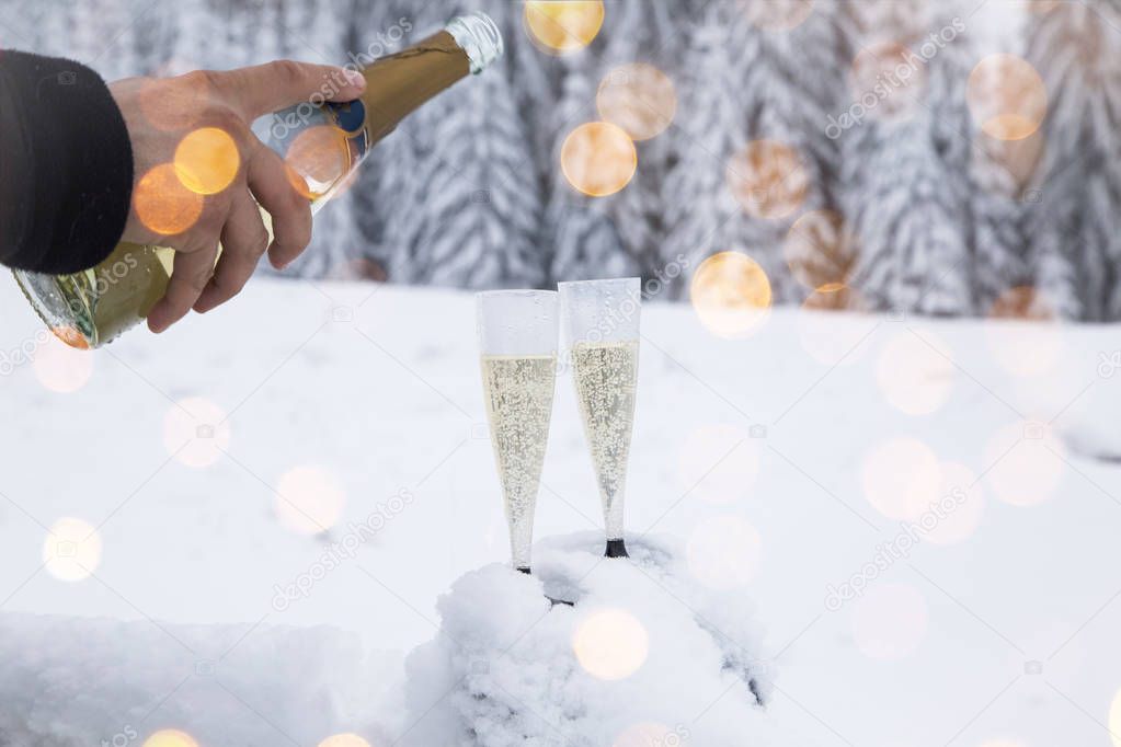 Champagne glasses in winter wonderland snow