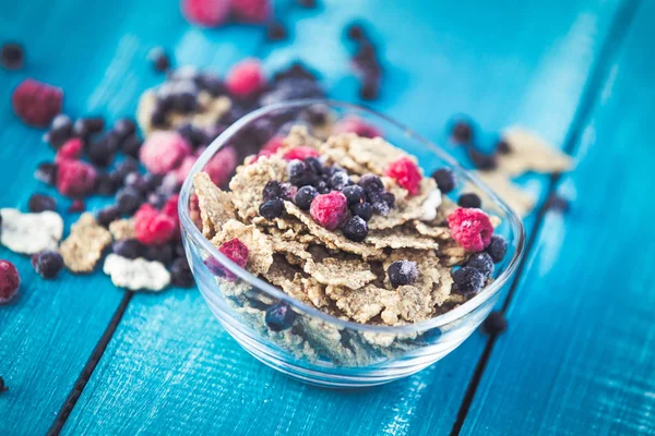 Cereal and forest berries on wooden background
