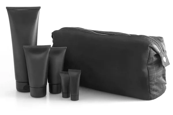 Black traveling cosmetic bag with toiletries in the front, isolated on white — Stock Photo, Image