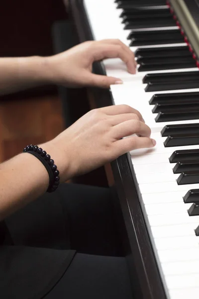 Young person playing the piano with both hands — Stock Photo, Image