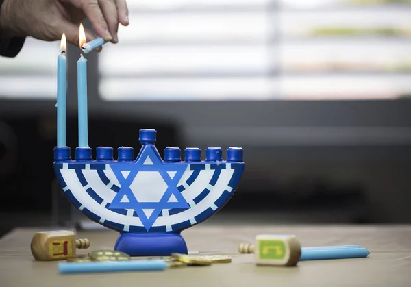Hanukkah candles lit for the holiday celebration surrounded by d — Stock Photo, Image