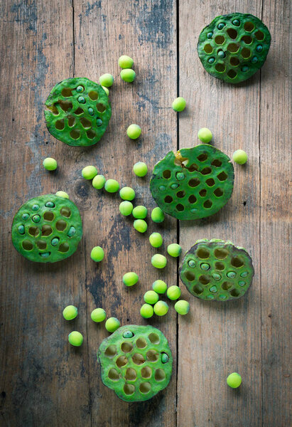 Lotus seeds and calyx on wooden background