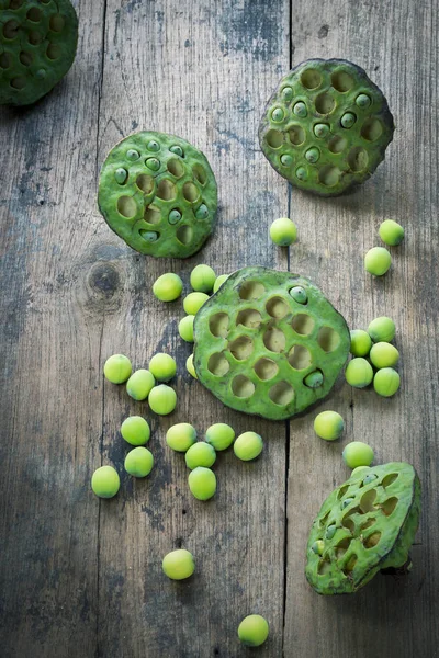 Lotus seeds and calyx on wooden background