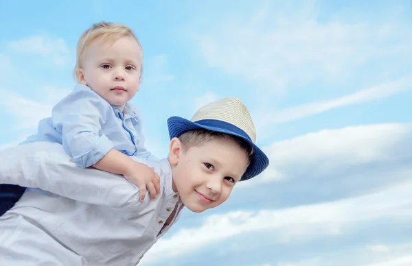 Podobizna chlapce usměvavá, dává jeho bratr Svezeme se o — Stock fotografie