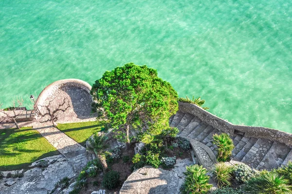 Top view of the sea. Nice view of the turquoise sea. Mediterranean Sea. Spain. Peniscola. Valencia  The descent to the sea and to the garden. The picturesque garden by the sea, the view from the top.