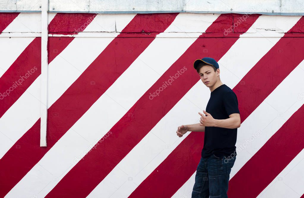 Stylish young man on a bright wall background