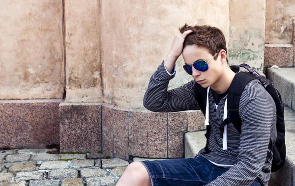 Stylish teenager resting on the stairs steps — Stock Photo, Image