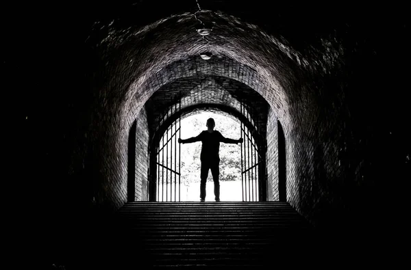 Teenager at the end of a dark tunnel — Stock Photo, Image