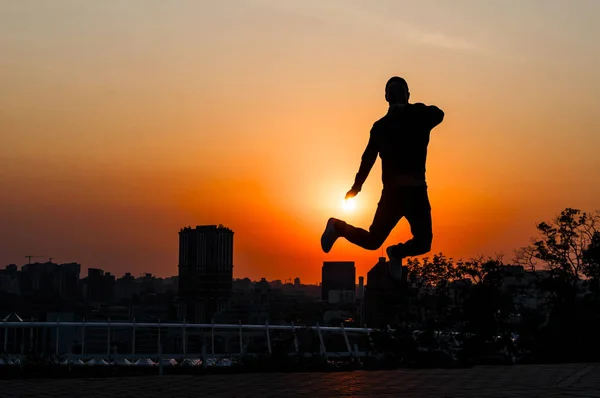 Silhouette of a young man on sunset background — Stock Photo, Image