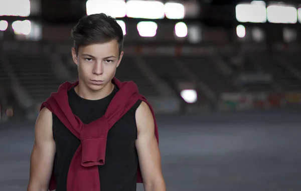 Serious young man in an old stadium, portrait — Stock Photo, Image