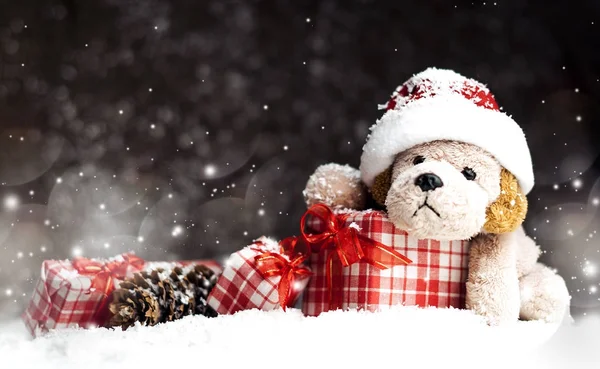 Decorative Christmas toy-dog, gifts in the snow Stock Image